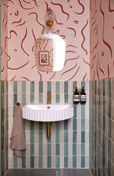 a bathroom with a sink, mirror and tiled walls