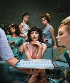 a group of women sitting around a table with a tray on it