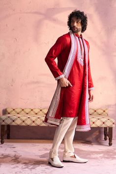 SHRESTHA BY VASTRAMAY Men's Red Silk Blend Machine Embroidered Kurta Pyjama With Silk Dupatta Set Elevate your ethnic wear collection with this luxurious red kurta pyjama set. Features machine embroidery on the neckline, a mandarin collar, and a comfortable fit. Paired with a cream pyjama and silk dupatta. Key Features Red silk blend fabric Machine embroidered neckline Mandarin collar Long sleeves Side slits Pockets (on kurta) Cream colored pyjama with elasticated waistband Silk dupatta Specific Red Kurta For Men, Men's Wedding Outfit, Red Kurta, Full Sleeve Top, Kurta Men, Kurta Pyjama, Dupatta Set, Embroidered Neckline, Sleeves Top