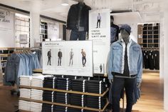 a clothing store display with mannequins and shirts