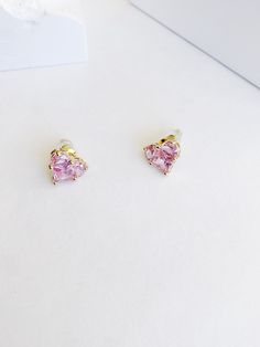 Each of these 14k gold earrings is embellished with a heart-shaped lab-created pink sapphire. Designed with friction backs, these stunning post earrings are polished to a bright shine, making them a lovely option she will want to wear often. Gold-Plated Brass Zirconia Stud Sterling Silver Posts Product Length: 11mm Product Width: 12mm Pink Heart Cut Earrings For Anniversary, Rose Gold Heart Cut Earrings, Elegant Pink Cubic Zirconia Heart Earrings, Elegant Pink Heart Earrings For Anniversary, Elegant Pink Heart Cut Earrings, Pink Fine Jewelry Heart Earrings As Gift, Pink Heart Earrings Fine Jewelry For Gifts, Pink Round Heart Earrings, Pink Cubic Zirconia Heart Earrings For Anniversary