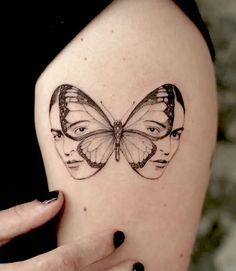 a woman's arm with a butterfly tattoo on the left side of her shoulder