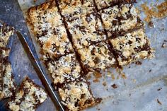 chocolate and coconut bars cut into squares on a baking sheet