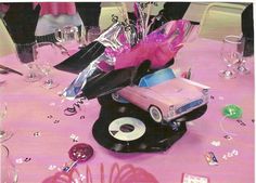 a table topped with pink and black decorations