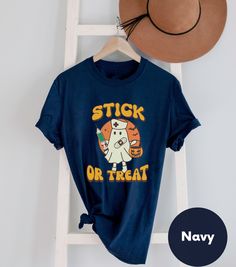 a t - shirt that says stick or treat on it next to a hat and ladder