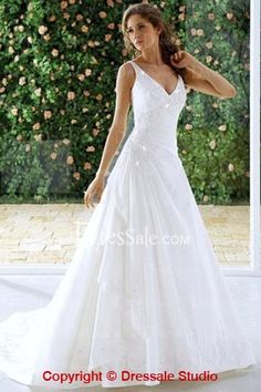 a woman in a white wedding dress posing for the camera