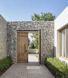 an open wooden door leading to a stone building