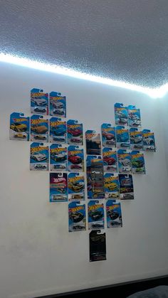 there are many cars on the wall with lights above it and below them is a bed