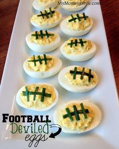 deviled eggs decorated with green crosses are on a white platter, ready to be eaten