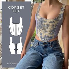 a woman sitting on a window sill with her back to the camera, wearing jeans and a corset top