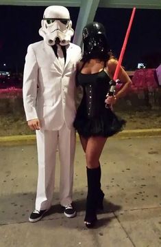 a man and woman dressed up as stormtrooper and darth vader are standing next to each other