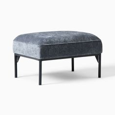 a grey ottoman with black legs on a white background