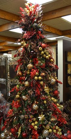 a christmas tree decorated with red and gold ornaments