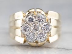 a yellow gold ring with two diamonds on the top and one diamond in the middle