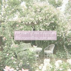 two white chairs sitting in front of a bush with flowers on it and a sign that says, for years you'll have me