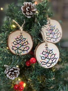 three wooden ornaments hanging from a christmas tree