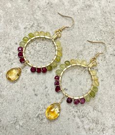 These earrings feature sparkly microfaceted gemstone beads and a citrine briolette wire wrapped in 14k gold filled wire.  The gemstones in these earrings include: - citrine - tsavorite garnet - plum tourmaline The beads and briolette are wrapped in 14k gold filled wire in a hoop-like design with the citrine dangling below the hoop.  All components of these earrings are handmade, and all of the gemstones are genuine, earth-mined gems.   These earrings: - are hypoallergenic; suitable for those wit Wire Wrapped Citrine Dangle Earrings, Small Hoop Jewelry With Faceted Beads For Gifts, Faceted Beads Briolette Earrings For Gift, Briolette Faceted Beads Earrings As Gift, Faceted Briolette Beads Earrings For Gift, Faceted Beads Dangle Hoop Earrings For Gifts, Hoop Jewelry With Faceted Beads For Gifts, Yellow Wire Wrapped Drop Earrings, Faceted Citrine Dangle Jewelry