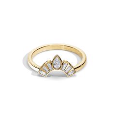 a yellow gold ring with three diamonds on the top and bottom, set against a white background