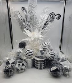 a basket filled with lots of different types of candies and candy canes on top of a table