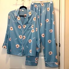 Ultra Soft Silk Button Down Long Sleeve And Long Pant With Elastic Waist Line. Size Listed Xl Top: Length: 26 Inches Armpit To Armpit: 21 In Sleeve: 21 In Pant: Waist Line: Measured Flat 12 In, Stretch To 20 In. Rise: 14 In Inseam: 26 In Casual Blue Floral Print Sleepwear, Blue Floral Print Long Sleeve Sleepwear, Blue Button-up Sleepwear With Button Closure, Spring Blue Sleepwear With Button Closure, Blue Spring Sleepwear With Button Closure, Blue Button Closure Sleepwear For Spring, Blue Long-sleeve Sleepwear With Buttons, Blue Long Sleeve Sleepwear With Buttons, Summer Blue Sleepwear With Button Closure