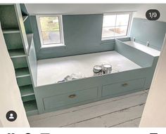 there is a room that has been painted blue with white paint on the walls and drawers