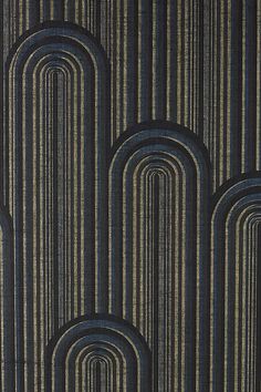 an art deco style wallpaper with black and gold stripes on it's surface