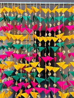 colorful kites hanging from the side of a building