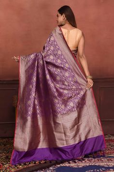 Radiate elegance on festive occasions in this beautiful purple Katan silk Banarasi saree with zari work. The saree has a pink edging. It comes with a matching blouse piece. Disclaimer: The shown stitched blouse on the model is for display purpose only. The saree comes with a matching blouse piece and finished with fall and piko. Disclaimer: The actual product may vary slightly from the image. These are custom orders, hence expect slight variation in color, placement of the motif or buta. ESTIMAT Silk Sarees Kanchipuram, Banarasi Sari, Silk Banarasi Saree, Tussar Silk Sarees, Indian Clothing Store, Latest Designer Sarees, Fashion Journals, Katan Silk, Tussar Silk Saree