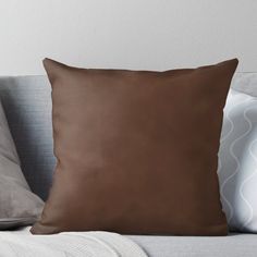 a brown pillow sitting on top of a couch