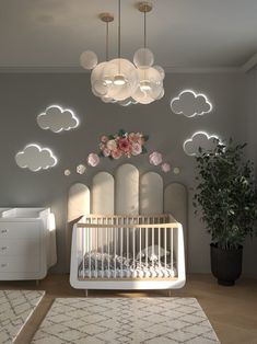 a baby's room with a white crib and flowers on the wall