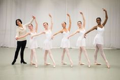 a group of ballerinas posing for a photo