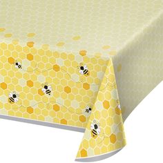 a table cloth with bees on it and yellow honeycombs around the edges,