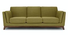 a green couch sitting on top of a wooden frame