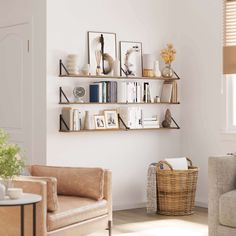 a living room with two couches and some bookshelves on the wall above them