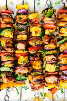 grilled vegetables and meats on skewers lined up