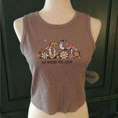 New With Tags Homegirl Society Graphic Crop Tank In A Mink Color Sporting Mushrooms And Daisies Encouraging To “ Go Where You Grow.” Lightweight Waffle Texture Material 60%Cotton 40% Polyester. Top Is Approx 17” Pit To Pit And 17.5” Shoulder To Hem. Rb1 Mushroom Graphic, Striped Tube Top, Texture Material, Mink Colour, Babydoll Tank, Girls Tie, Pleat Top, Lululemon Tops, Tie Dye Tank Top