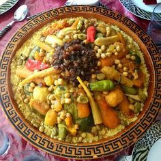 a bowl filled with lots of different types of food on top of a red table cloth