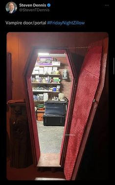 an open door leading into a room with shelves on either side and a red bed in the middle