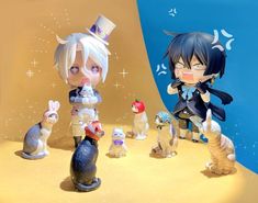 two anime figurines are standing next to each other in front of a blue background