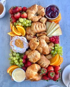 an assortment of pastries and fruit on a tray