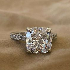 a cushion cut diamond ring with pave set shoulders