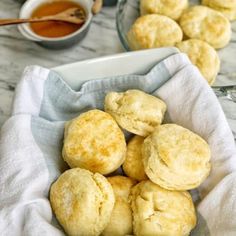 some biscuits are in a white bowl on a table