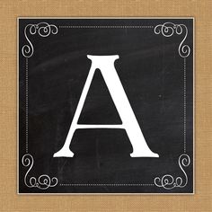 a black and white sign with the letter a in it's center on a burlap background