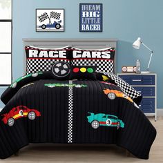 a bed with race cars on it in a room