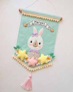 a wall hanging with a bunny and stars on it