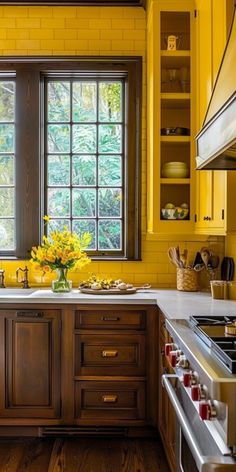 a kitchen with yellow painted walls and wooden cabinets, white counter tops, and wood flooring