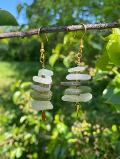 Each earring is made with 5 pieces of authentic seaglass from the Brittany region of France. They are lightweight and fun, perfect statement earrings! Beach Earrings With Sea Glass And Ear Wire, Beach Earrings With Recycled Glass And Ear Wire, Handmade Sea Glass Dangle Earrings, Handmade Sea Glass Drop Earrings, Beach Sea Glass Earrings With Ear Wire, Ocean-inspired Drop Shell Earrings, Green Recycled Glass Earrings For Beach, Handmade Sea Glass Green Earrings, Bohemian Shell-shaped Earrings For Vacation