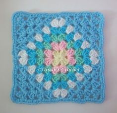 a crocheted square with a flower in the center