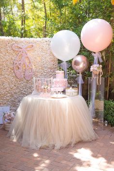 a table with balloons and cake on it