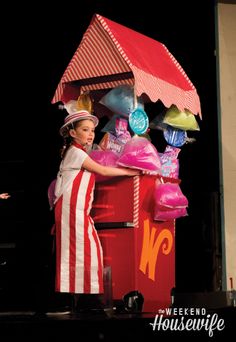 a woman standing in front of a candy machine